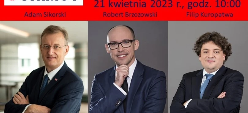 Dwóch biznesmenów ubranych w formalne stroje z marynarkami, krawatami i koszulami w trakcie dyskusji na spotkaniu biznesowym. Logo UNIMOT jest widoczne.