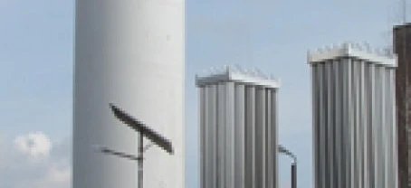 Zbiornik magazynowy wykonany z materiału kompozytowego w ustawieniu fabrycznym przemysłowym z rurami i maszynami. Inżynierskie cuda cylindrów i silosów w działaniu.