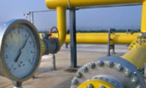 Zblizenie rur i cylindrycznych elementów metalowych na przemysłowej stacji pomp. To zdjecie przedstawia inzynierie i budowe instalacji hydraulicznej.